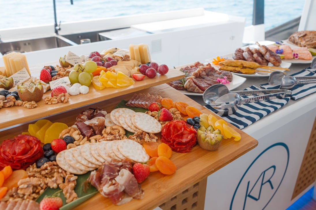 a buffet of food on a boat with a view of the ocean